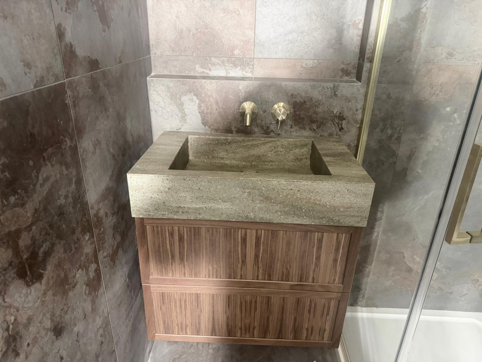 Overhead view of concrete vanity with wood unit