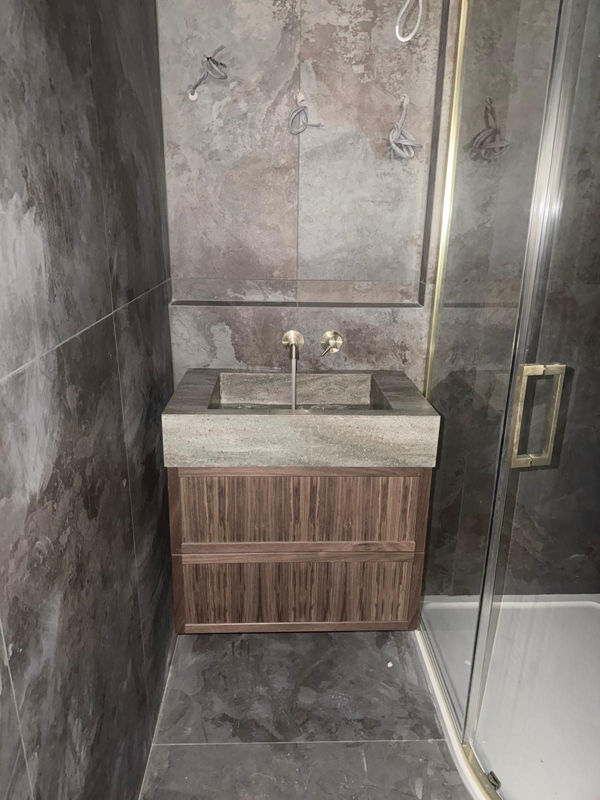 Stone concrete vanity sink with brushed brass wall tap